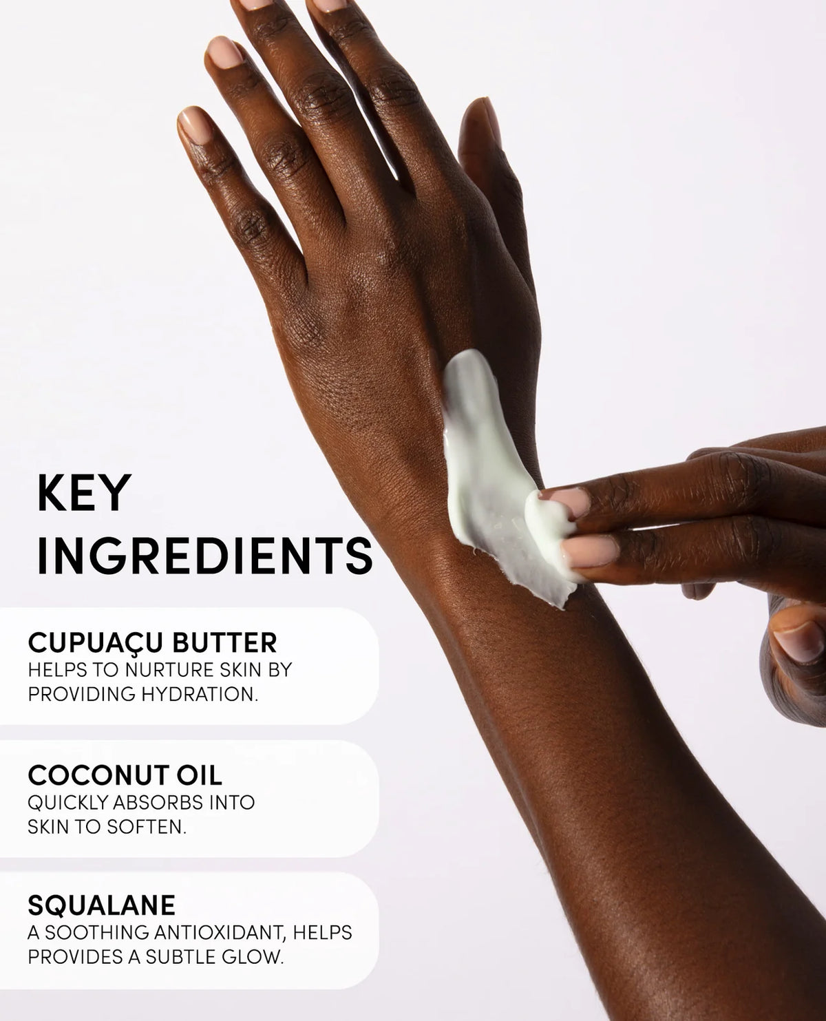 Hand applying cream with key ingredients listed on a white background