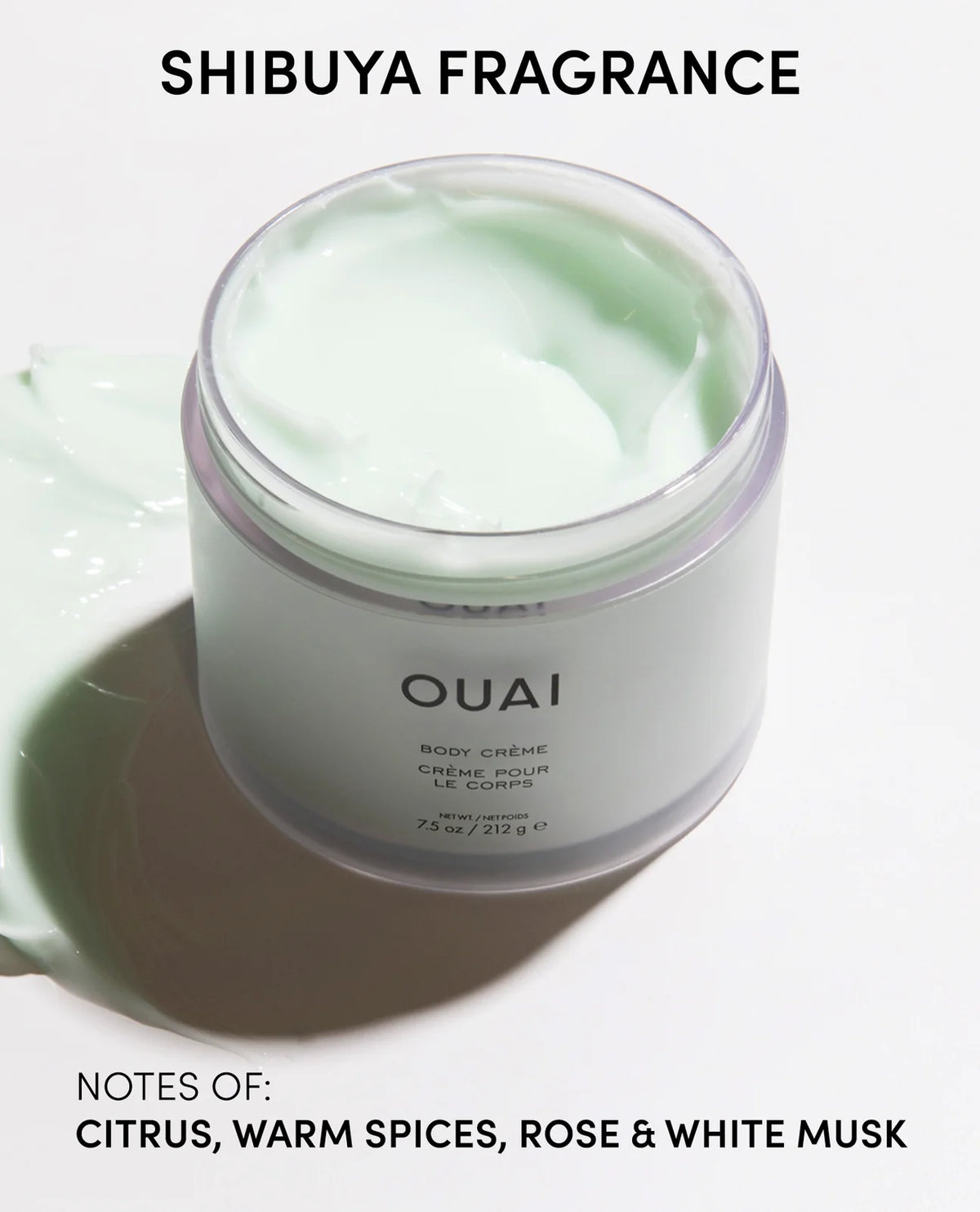 A jar of OUAI Shibuya Fragrance body creme with pale mint green cream visible inside, on a white background with text describing the scent notes.
